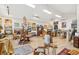 Bright and airy artist studio with hardwood floors, artwork, windows, and comfortable furnishings at 1612 John Fenwick Ln, Johns Island, SC 29455