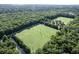 Wide aerial view of soccer fields surrounded by lush green trees with a canal at 1616 Dotterers Run, Charleston, SC 29414