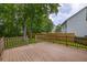Spacious back deck featuring a wooden railing overlooking the serene backyard landscaping at 1616 Dotterers Run, Charleston, SC 29414