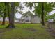 Spacious backyard with mature trees, featuring a deck and plenty of green space for outdoor activities and enjoyment at 1616 Dotterers Run, Charleston, SC 29414