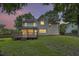 Back elevation of a home featuring large backyard, wooden deck, and ample natural light from many windows at 1616 Dotterers Run, Charleston, SC 29414