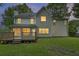 Rear exterior view of a home with a backyard deck and abundant windows allowing natural light at 1616 Dotterers Run, Charleston, SC 29414