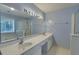 Bright bathroom featuring a double sink vanity, large mirror, tub, and glass-enclosed shower at 1616 Dotterers Run, Charleston, SC 29414