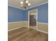 Dining room with blue and gold accents, modern flooring, and view into the kitchen at 1616 Dotterers Run, Charleston, SC 29414