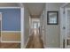 Hallway with hardwood flooring, neutral walls, and visible doorways that offer depth at 1616 Dotterers Run, Charleston, SC 29414