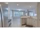 Kitchen features white cabinetry, quartz countertops, stainless steel appliances, and natural lighting at 1616 Dotterers Run, Charleston, SC 29414
