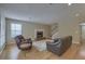 Living room with hardwood floors, a brick fireplace, and comfortable leather furniture at 1616 Dotterers Run, Charleston, SC 29414
