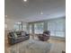 Cozy living room features a leather sofa, armchair, and a decorative area rug on hardwood flooring at 1616 Dotterers Run, Charleston, SC 29414