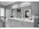 Bathroom boasts dual sinks, white cabinetry, and a large framed mirror over the vanity at 163 Golfview Ln, Summerville, SC 29485