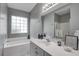 Bathroom features white cabinets, vanity, and a window for natural light over the soaking tub at 163 Golfview Ln, Summerville, SC 29485