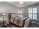 Cozy bedroom with a comfortable bed, side tables with lamps, and a shuttered window at 163 Golfview Ln, Summerville, SC 29485