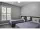 Comfortable bedroom with two twin beds, soft carpet, and natural light from the shuttered window at 163 Golfview Ln, Summerville, SC 29485