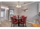 Dining area with a glass table, red chairs, stylish decor, and plenty of natural light at 163 Golfview Ln, Summerville, SC 29485