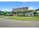 Charming two-story home with a metal roof, a wide porch and manicured landscaping at 163 Golfview Ln, Summerville, SC 29485
