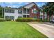Inviting two-story condo with a brick facade, screened porch, lush lawn, and a private driveway at 163 Golfview Ln, Summerville, SC 29485