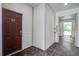 Hallway with red door, tile floors, and white siding; fire extinguisher visible at 163 Golfview Ln, Summerville, SC 29485
