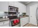 Modern kitchen with stainless steel oven and microwave, along with ample white cabinet storage and granite countertops at 163 Golfview Ln, Summerville, SC 29485