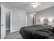 Spacious bedroom features plush carpeting, lighted ceiling fan, and glass bedside table with lamps at 163 Golfview Ln, Summerville, SC 29485