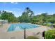 Community pool surrounded by lounge chairs, tables, and lush landscaping at 163 Golfview Ln, Summerville, SC 29485