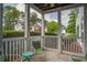 Relaxing screened porch with green chairs offering serene views of the surrounding neighborhood at 163 Golfview Ln, Summerville, SC 29485