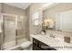 Bathroom features tiled shower with glass door, granite countertop vanity with white flowers for an elegant touch at 167 Surfbird Rd # 649P, Summerville, SC 29486