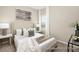 Cozy bedroom with a plush bed, decorative pillows, side tables with lamps, and stylish modern artwork at 167 Surfbird Rd # 649P, Summerville, SC 29486