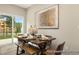 Bright dining area with sliding glass door, wood table, comfortable bench, and attractive artwork at 167 Surfbird Rd # 649P, Summerville, SC 29486