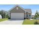 Charming one-story home features a spacious two-car garage, well-maintained lawn, and inviting front entrance at 167 Surfbird Rd # 649P, Summerville, SC 29486