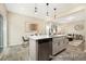 Open concept kitchen with an island, stainless steel dishwasher, wood floors, and stylish pendant lighting at 167 Surfbird Rd # 649P, Summerville, SC 29486
