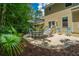Backyard patio featuring outdoor seating under umbrella, mature trees, and lawn at 1721 Wellstead St, Mount Pleasant, SC 29466