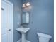 Stylish powder room showcasing a pedestal sink, ornate mirror, and elegant fixtures at 1721 Wellstead St, Mount Pleasant, SC 29466