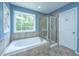 Well-lit bathroom featuring a soaking tub, glass shower, and natural light at 1721 Wellstead St, Mount Pleasant, SC 29466