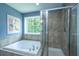 Well-lit bathroom featuring a soaking tub, glass shower, and natural light at 1721 Wellstead St, Mount Pleasant, SC 29466