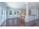 Bright dining area with large windows, hardwood floors, and views into an adjacent kitchen and living space at 1721 Wellstead St, Mount Pleasant, SC 29466