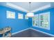 Cozy dining space featuring a modern chandelier, plantation shutters and blue walls at 1721 Wellstead St, Mount Pleasant, SC 29466