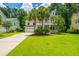 Charming two-story home with double porches, a well-manicured lawn, and palm trees at 1721 Wellstead St, Mount Pleasant, SC 29466