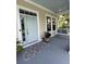 Inviting front porch with a swing, stylish rug, and refreshing blue ceiling, creating a relaxing outdoor space at 1721 Wellstead St, Mount Pleasant, SC 29466