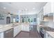 Modern kitchen with white cabinetry, granite counters, stainless appliances, and an open layout to the living area at 1721 Wellstead St, Mount Pleasant, SC 29466