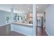 Modern kitchen with stainless steel appliances, granite counters, and an island opening up to an open living area at 1721 Wellstead St, Mount Pleasant, SC 29466