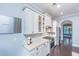 A stylish kitchen featuring white cabinetry, granite countertops, stainless steel appliances, and a mosaic tile backsplash at 1721 Wellstead St, Mount Pleasant, SC 29466