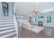 Bright living room with fireplace, built-ins, and staircase with dark wood floors at 1721 Wellstead St, Mount Pleasant, SC 29466