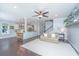 Open-concept living room boasts dark wood floors, ceiling fan, and seamless flow to the modern kitchen at 1721 Wellstead St, Mount Pleasant, SC 29466