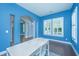Bright and airy office space with white shutters, blue walls, and hardwood floors at 1721 Wellstead St, Mount Pleasant, SC 29466