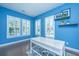 Inviting blue office showcasing natural light, built-in shelves and modern decor at 1721 Wellstead St, Mount Pleasant, SC 29466