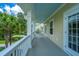 Large porch overlooking trees with outdoor seating and light blue ceiling at 1721 Wellstead St, Mount Pleasant, SC 29466