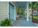 Welcoming porch area with a cozy swing, stylish rug, and a charming blue ceiling at 1721 Wellstead St, Mount Pleasant, SC 29466