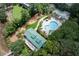 Community aerial view showcasing a pool, playground, and green spaces surrounded by lush landscaping and homes at 1809 Rushland Grove Ln, Johns Island, SC 29455