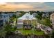 Expansive aerial view of home with lush landscaping, fire pit, outdoor seating and neighborhood surroundings at 1809 Rushland Grove Ln, Johns Island, SC 29455