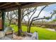 Enjoy a serene backyard view from the covered patio, featuring a treehouse and natural landscape at 1809 Rushland Grove Ln, Johns Island, SC 29455