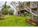 Lush backyard featuring a well-maintained lawn and mature trees, offering a serene outdoor space at 1809 Rushland Grove Ln, Johns Island, SC 29455